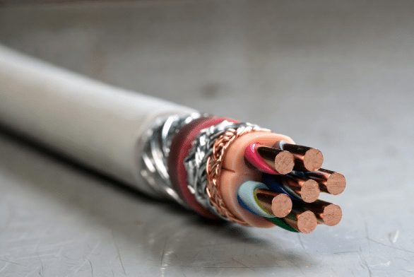 Detailed cross-section view of a custom industrial cable revealing layered construction including conductors, insulation, foil shield, copper braid and outer jacket, helping engineers understand shielding options for EMI protection in automation environments.