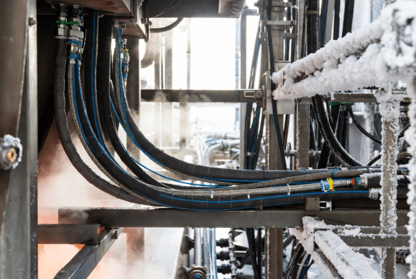 Realistic view of custom cables routed in hot machinery areas and cold storage demonstrating differences between installation temperature and operating temperature ratings