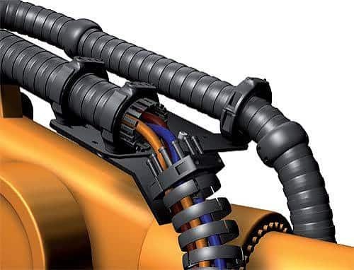 Industrial robotic arm equipped with a cable management dress pack system, featuring protective conduits and guided cables to prevent wear, reduce bending stress, and support reliable multi-axis robot movement in automation applications.
