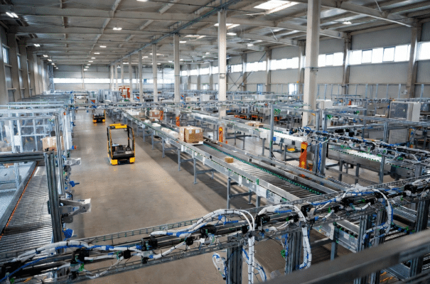 Modern automated warehouse featuring conveyor belts, multiple sensors, and reliable high-flex sensor cabling connecting automation components in a clean, high-tech distribution center
