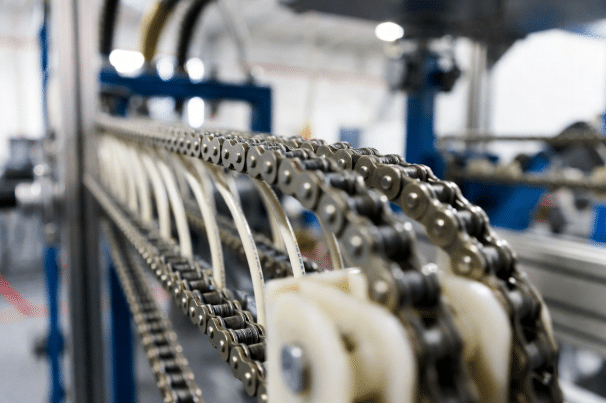 Close-up of well-maintained clean drag chain cables and guide troughs free of debris, demonstrating proper cleaning practices for energy chains in 24/7 production environments