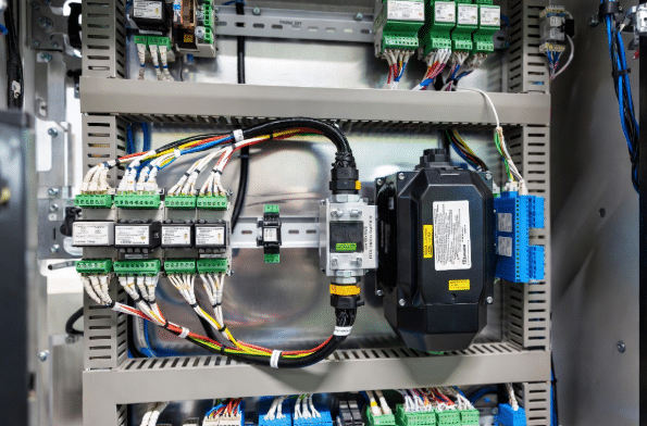 Overview of full servo cable harness with power, feedback, encoder and brake cables clearly labeled, connected in industrial control setup for motion systems