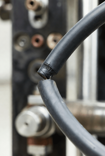 Close-up of silicone cable at stress point showing early mechanical fatigue signs like minor abrasion in industrial motion system for maintenance and inspection guidance