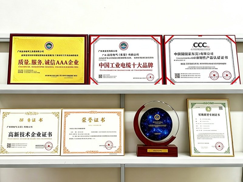 Display of HULK's prestigious industry awards and certifications, including the 'Top 10 Industrial Cable Brands in China' plaque, AAA Enterprise credit rating, High-tech Enterprise certificate, and CCC safety compliance marks.