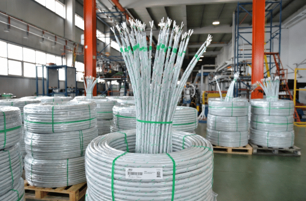 Professional view of high-performance halogen-free cables arranged in a modern green-certified manufacturing plant, highlighting eco-friendly industrial cabling solutions for automation and robotics