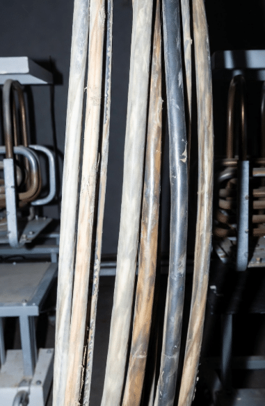Close-up of silicone insulated cables exposed to high heat sources showing material condition and flexibility considerations for long-term thermal performance in factory applications