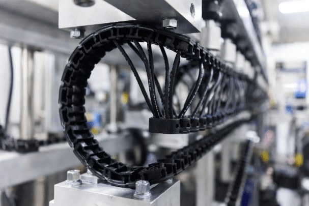 Properly routed silicone cables in automated drag chain showing dynamic motion setup in factory machinery for extended lifespan in industrial automation