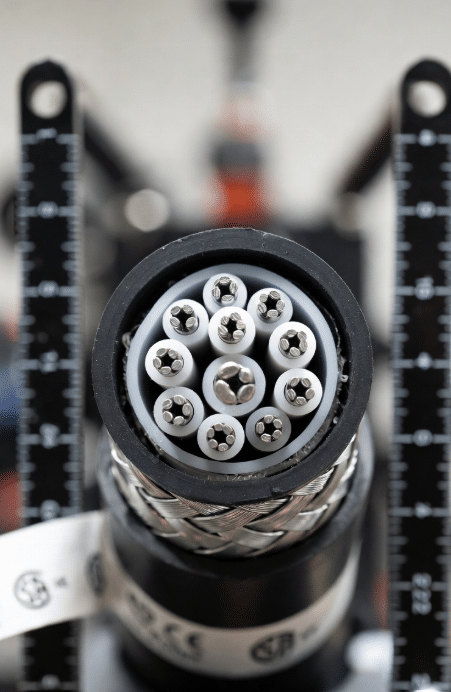 Detailed close-up cross-section of custom high-temperature silicone cable revealing multi-strand conductors, insulation layers, shielding and durable jacket, essential for understanding performance in extreme conditions
