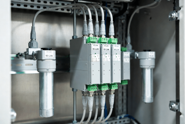 IO-Link sensors interconnected with standard and custom M12 cables to master module in factory control setup for sensor networking