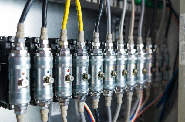 Robust M12 circular connectors on industrial IO module demonstrating versatility for sensors actuators and Ethernet in factory environment
