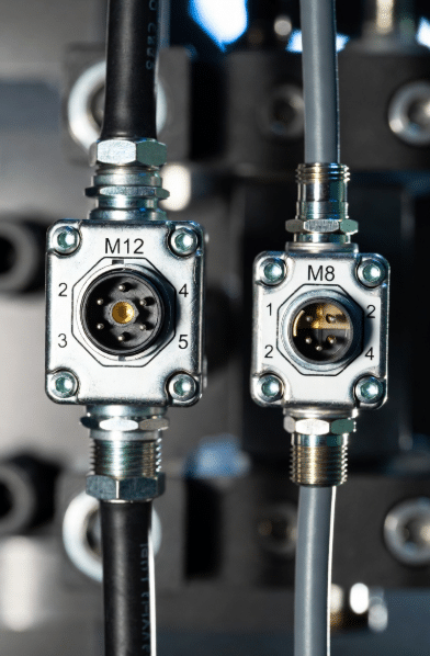 Detailed view of M12 and M8 connectors showing pin assignments and flexible cable construction used in IO-Link cabling for sensors and actuators in industrial environments