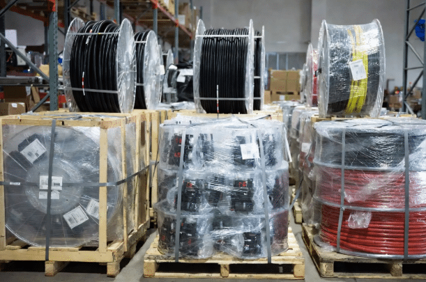 Professionally packaged industrial cable reels and harnesses on pallets with export labeling and protective materials