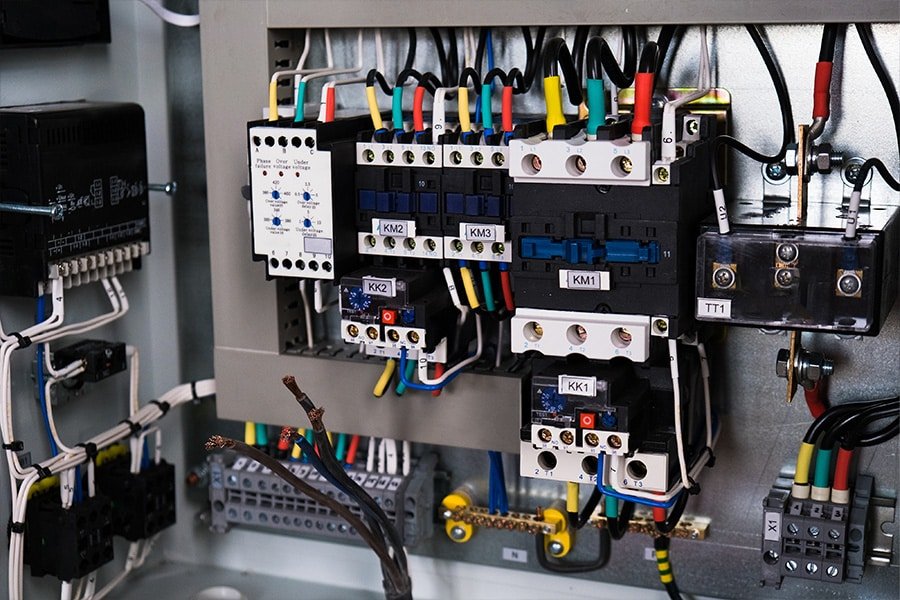 Neatly arranged multicolor wires connected to terminal blocks inside an industrial control cabinet, emphasizing professional wiring practices and system reliability