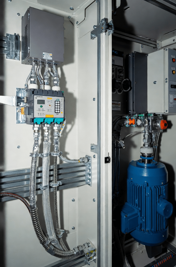 Industrial photo demonstrating 360° EMC gland and shield clamp installation on shielded servo cables for effective grounding and EMC control in VFD systems