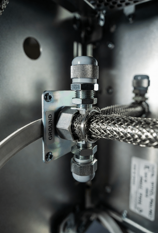 Close-up of professional 360-degree shield termination and low-impedance grounding for servo motor cables, avoiding pigtails for optimal EMI performance