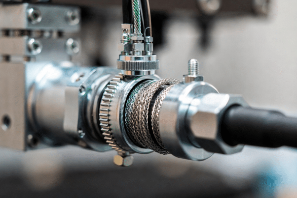 Detailed view of 360-degree shield grounding termination using connector backshell for low-impedance path in shielded torsion cables for robots