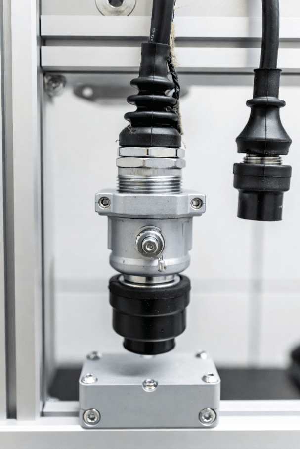 Detailed view of robot torsion cable at connector with strain relief, showing potential failure areas in automation setup