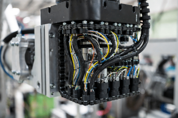 Close-up of high-flex custom cables for robotics inside energy chain carrier, illustrating continuous flex life and bend radius best practices for AGV and warehouse robot applications
