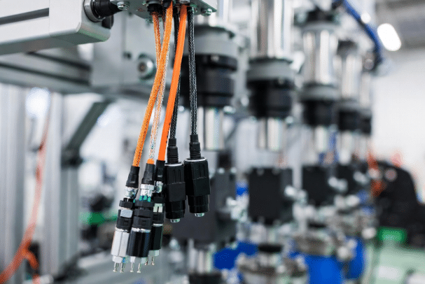 High-flex servo motor power and feedback cables installed on servo motors and drives in a modern robotic or CNC automation cell, highlighting braided shielding and durable jackets for reliable motion control
