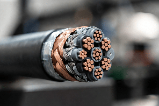 Close-up professional view of cutaway high-flex drag chain cable revealing detailed foil, braided copper, and hybrid shielding construction around conductors for EMI protection in dynamic automation applications