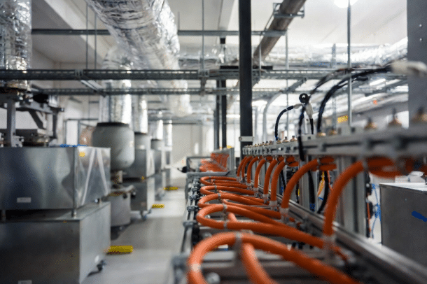 Clean installation of heat-resistant silicone cables near heaters and ductwork in an industrial HVAC system, professional facility view