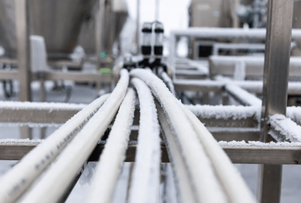 High-performance silicone cables showing excellent flexibility and no brittleness in a sub-zero food processing or refrigerated industrial setting, mounted near equipment with visible cold conditions