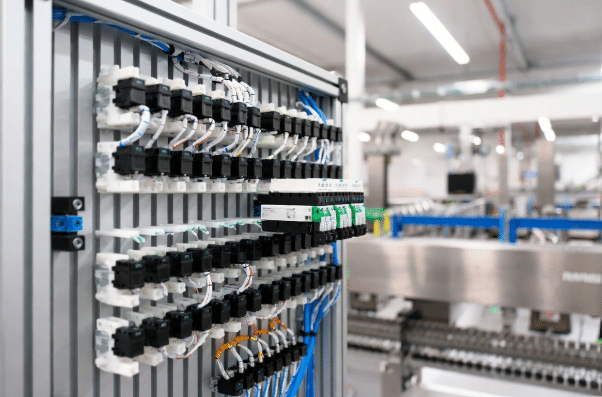 Clean multi-axis servo drive panel with single hybrid cables reducing complexity in automation control cabinet