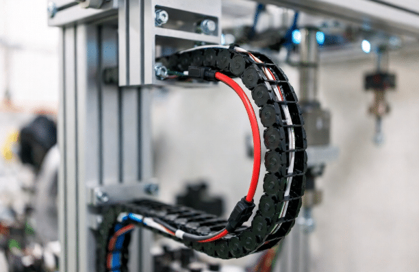 Clean routing of one hybrid servo cable inside a cable carrier on CNC or robotic equipment, highlighting reduced density and simplified installation compared to multiple separate cables