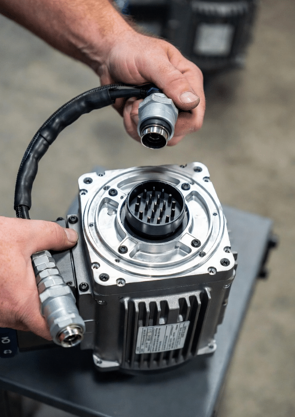 Engineer inspecting and replacing single hybrid servo cable, illustrating maintenance considerations for single-cable architectures