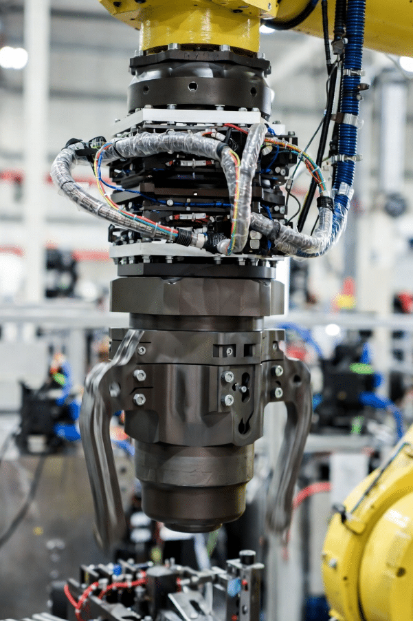 Realistic view of robot joint where cables experience twisting torsion motion, key for selecting torsion-rated robot cables over standard bending types