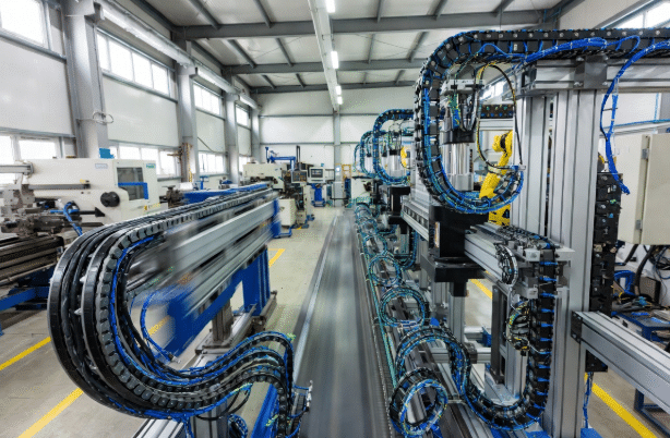Side-by-side view of standard catalog drag chain cables versus advanced custom continuous-flex cables installed in energy chains on factory automation equipment, highlighting motion and design differences