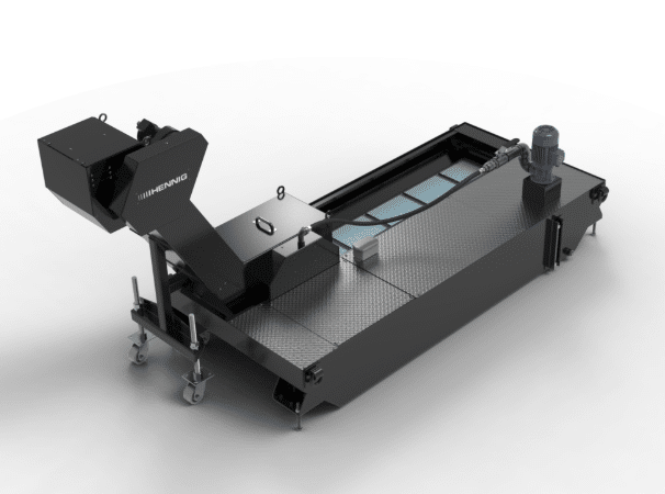 Industrial view of flexible drag chain cables handling aggressive oils, coolants, metal chips and heat in machine tool application, illustrating requirements for custom chemical-resistant jackets