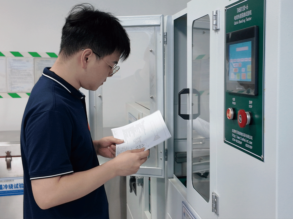 Engineer reviewing a test report beside a HULK TH8015D-6 Cable Bending Tester; the white machine with a green control panel and digital display is used to simulate high-frequency, small-radius bending cycles, validating cable durability under repeated flexing — with human oversight ensuring data accuracy and process compliance.