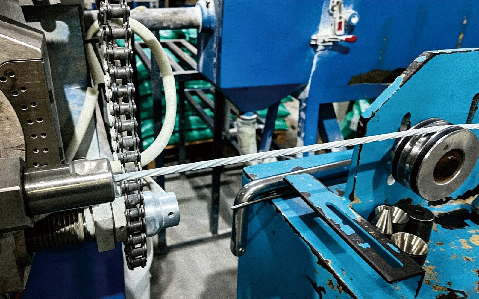 Close-up of the stranding process for HULK cable's internal tensile members (likely aramid fibers or steel wires); the machinery twists these high-strength elements to form a robust core that provides exceptional pull resistance and prevents elongation in vertical or heavy-duty drag chain applications.