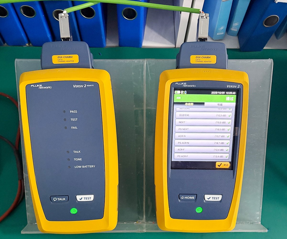 HULK Cat 8 network cable undergoing certification test with Fluke Networks Versiv 2 testers; right unit displays “PASS” with all parameters (Return Loss, NEXT, ACR-N, etc.) meeting standards, left unit shows green “PASS” LED — validating HULK cables for high-speed data centers and enterprise networks requiring guaranteed signal integrity and compliance.