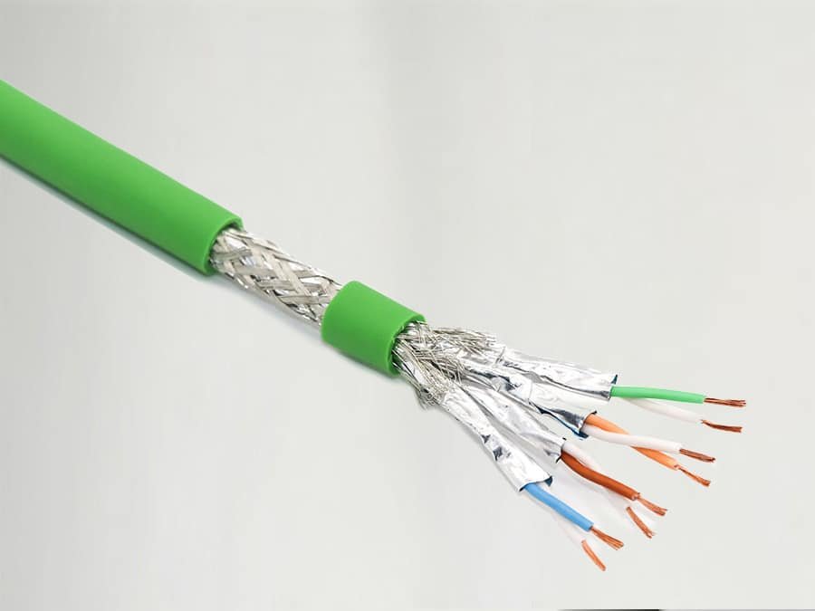Cross-section of HULK dual-shielded industrial Ethernet cable showing four color-coded twisted pairs (orange, green, blue, brown) enclosed by silver braided shield and aluminum foil layer, all under green outer jacket — engineered for maximum EMI/RFI rejection and signal integrity in high-noise industrial environments.