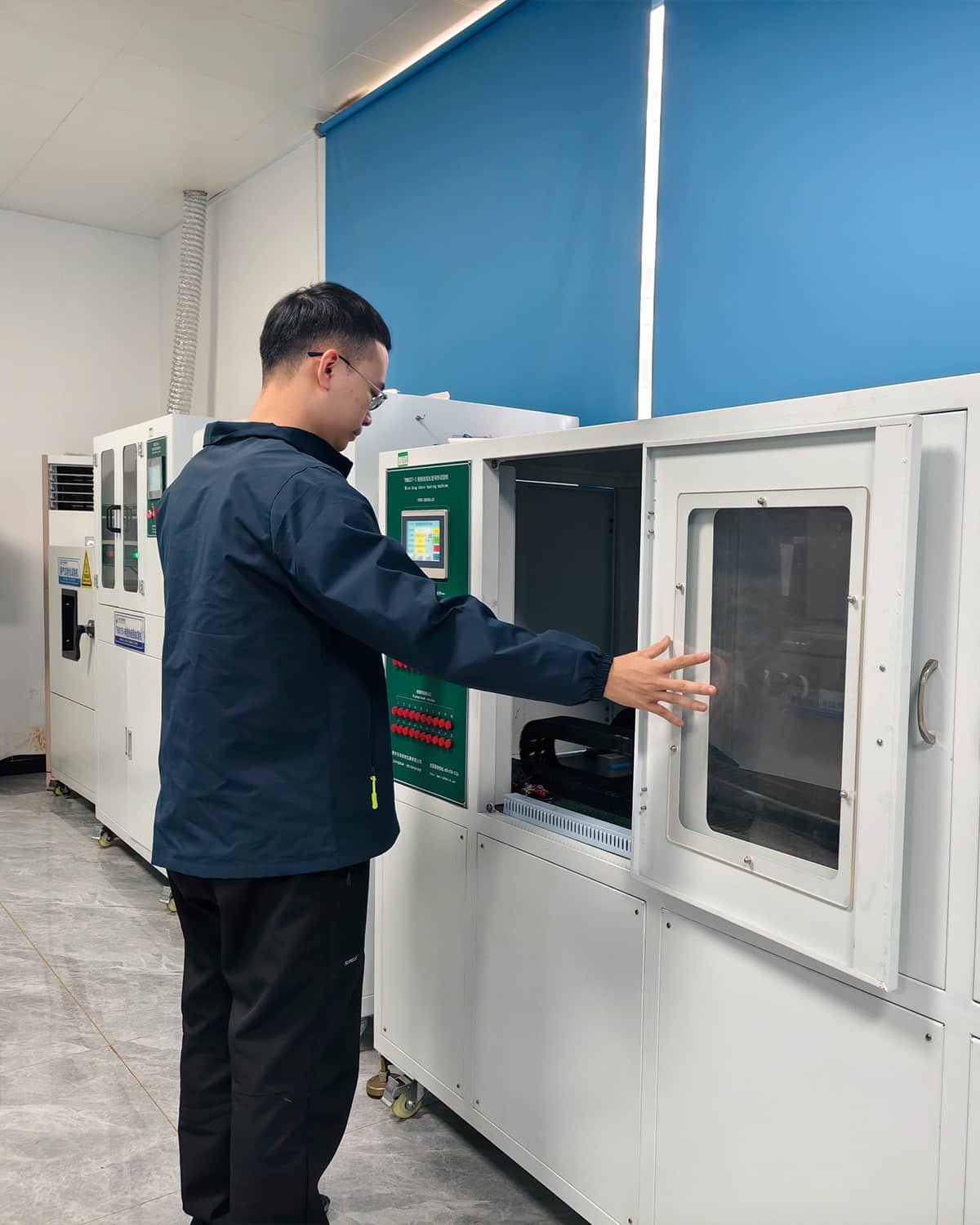HULK engineer operating a large environmental test chamber to simulate extreme temperature and humidity conditions, validating the long-term aging resistance and reliability of cable materials.