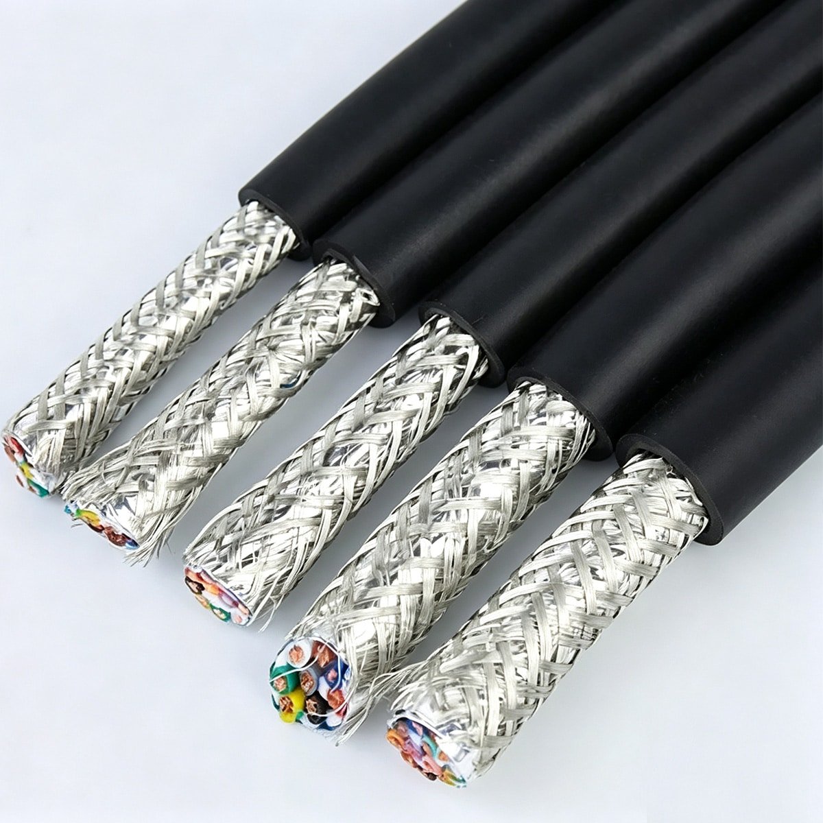 Five HULK high-flex drag chain cables with black outer jackets and dense tinned copper braided shielding, revealing multi-colored insulated conductors inside — engineered for continuous flexing, torsion resistance, and long service life in automated machinery and robotic cable carriers.
