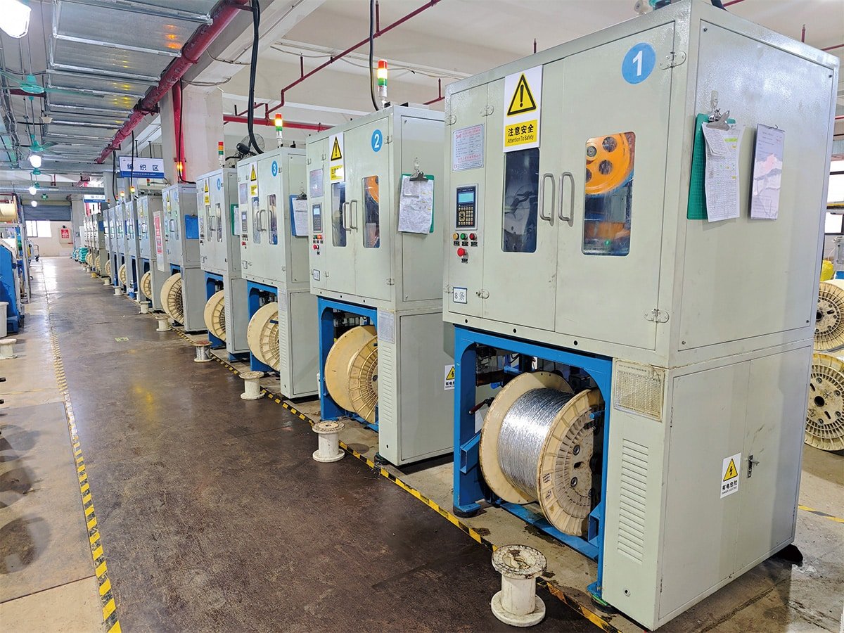 HULK automated braiding machines producing high-density metallic shielding layers for industrial cables, ensuring superior EMI protection and signal integrity through precise process control.