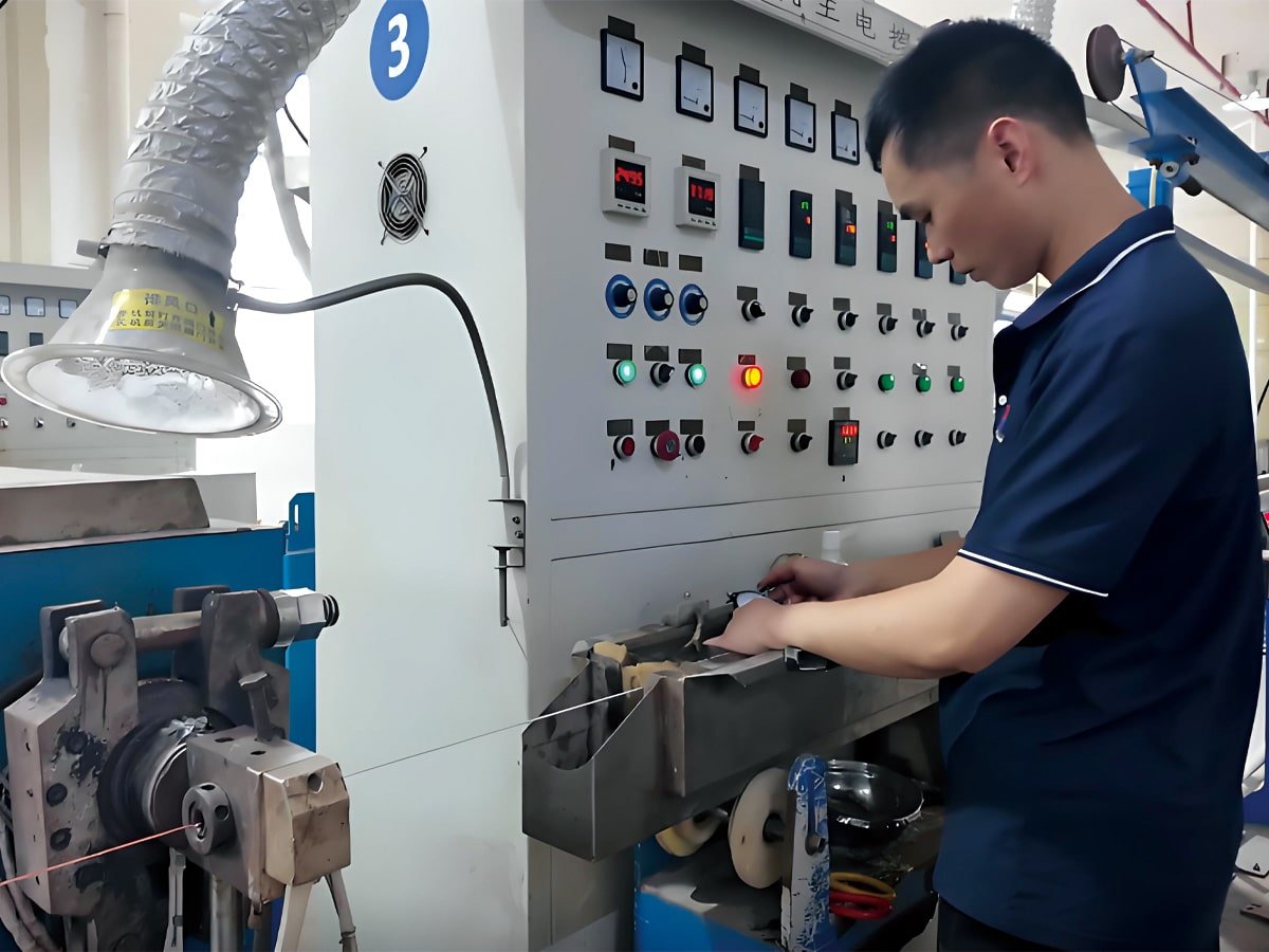 A HULK technician meticulously monitoring the cable extrusion control panel, adjusting parameters to ensure precise insulation thickness and concentricity during the manufacturing process.