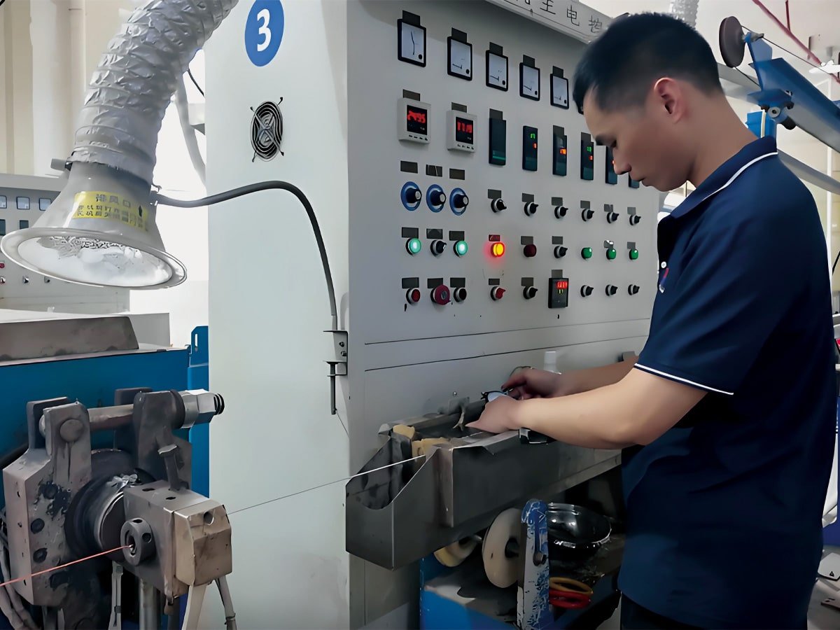 HULK technician monitoring the extrusion process at a complex control panel with gauges and indicators, ensuring precise parameter adjustment and quality consistency during cable manufacturing.