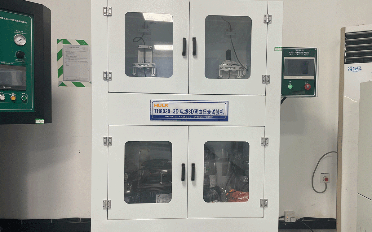 Front view of the HULK TH8030-3D Cable 3D Torsion Tester, a white dual-chamber cabinet with transparent windows revealing internal clamping mechanisms — designed to simulate combined bending and torsional stresses in 3D space, validating cable integrity under complex motion profiles such as robotic arms and rotating platforms.