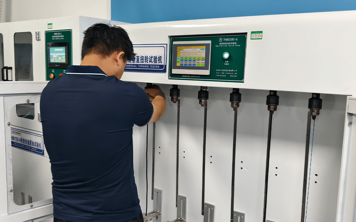 Front view of the HULK TH8030C-6 Cable Vertical Torsion Tester, featuring a green control panel with touchscreen interface and multiple vertical clamping stations — designed to simulate torsional stress under gravity in vertical installation scenarios such as elevator shafts and overhead cabling, ensuring long-term mechanical and electrical reliability.