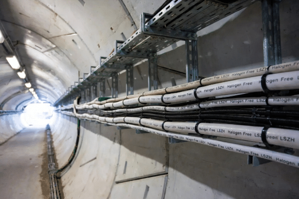 Professional view of halogen-free LSZH cables neatly installed along cable trays in a subway tunnel, highlighting fire safety features and organized transit infrastructure for low-smoke performance in rail applications