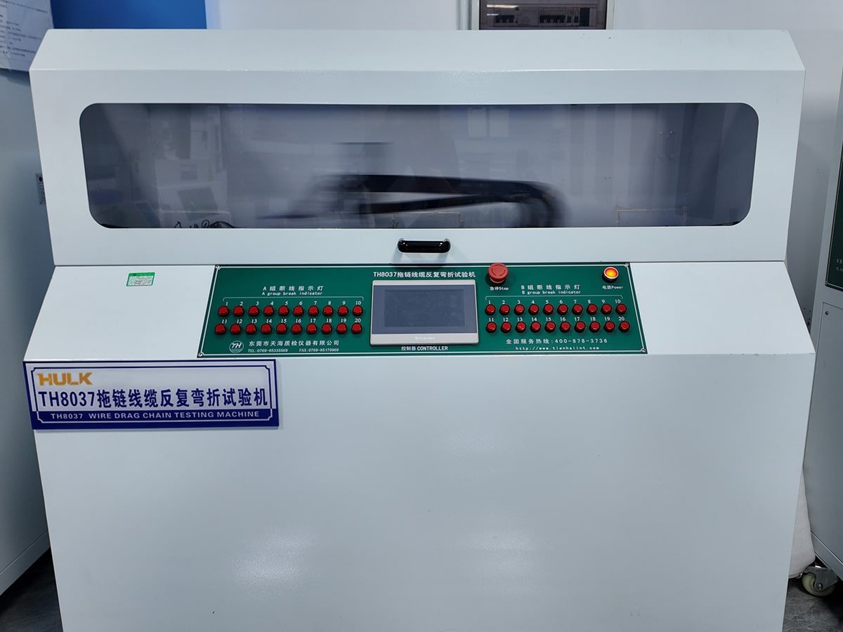 Hulk Cable TH8037 Wire Drag Chain Testing Machine with dual-group break indicators, emergency stop, and central controller, performing high-frequency reciprocating bending tests on multiple cables to validate durability in drag chain applications