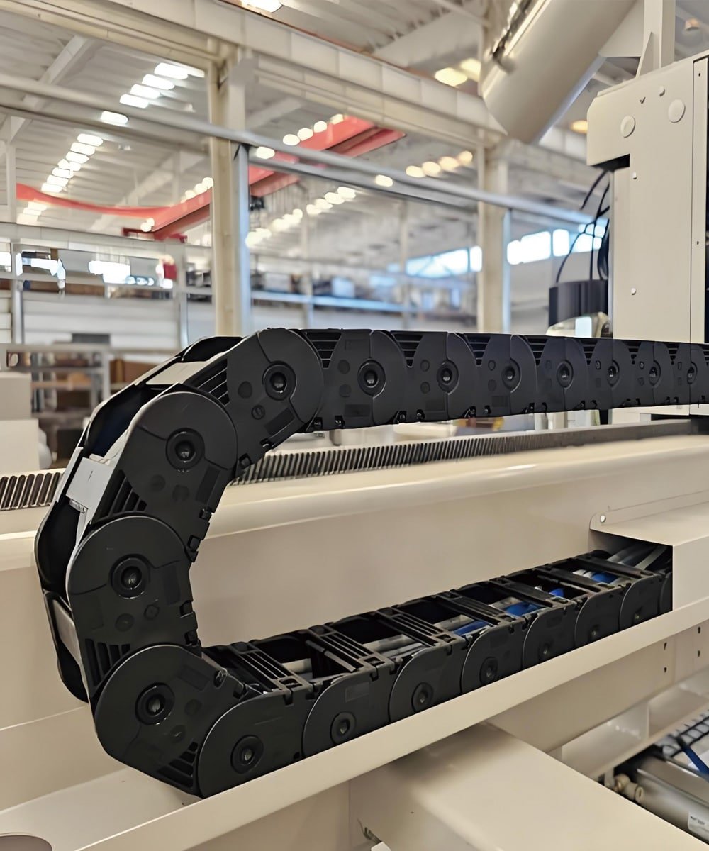 Hulk Cable automated equipment application scene showing black engineering plastic drag chain with integrated high-flex shielded cables, demonstrating reliable cable protection and management in high-dynamic motion environments