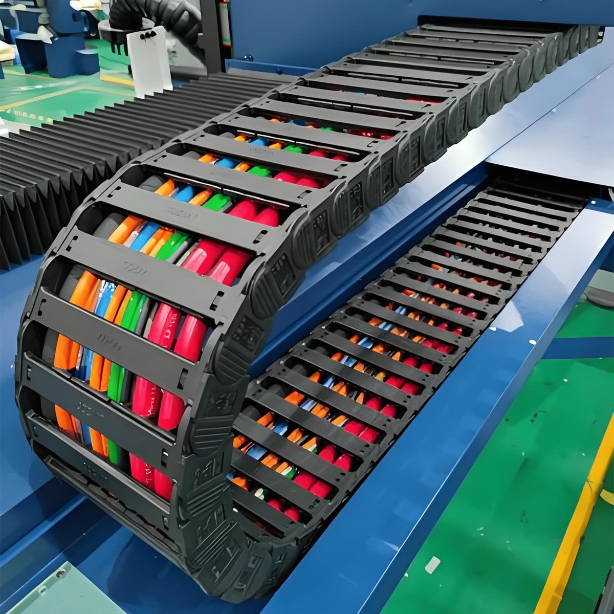 Hulk Cable heavy-duty bridge-type plastic drag chain system with multi-colored cables organized inside, designed for high-frequency motion protection in CNC machines and automated production lines