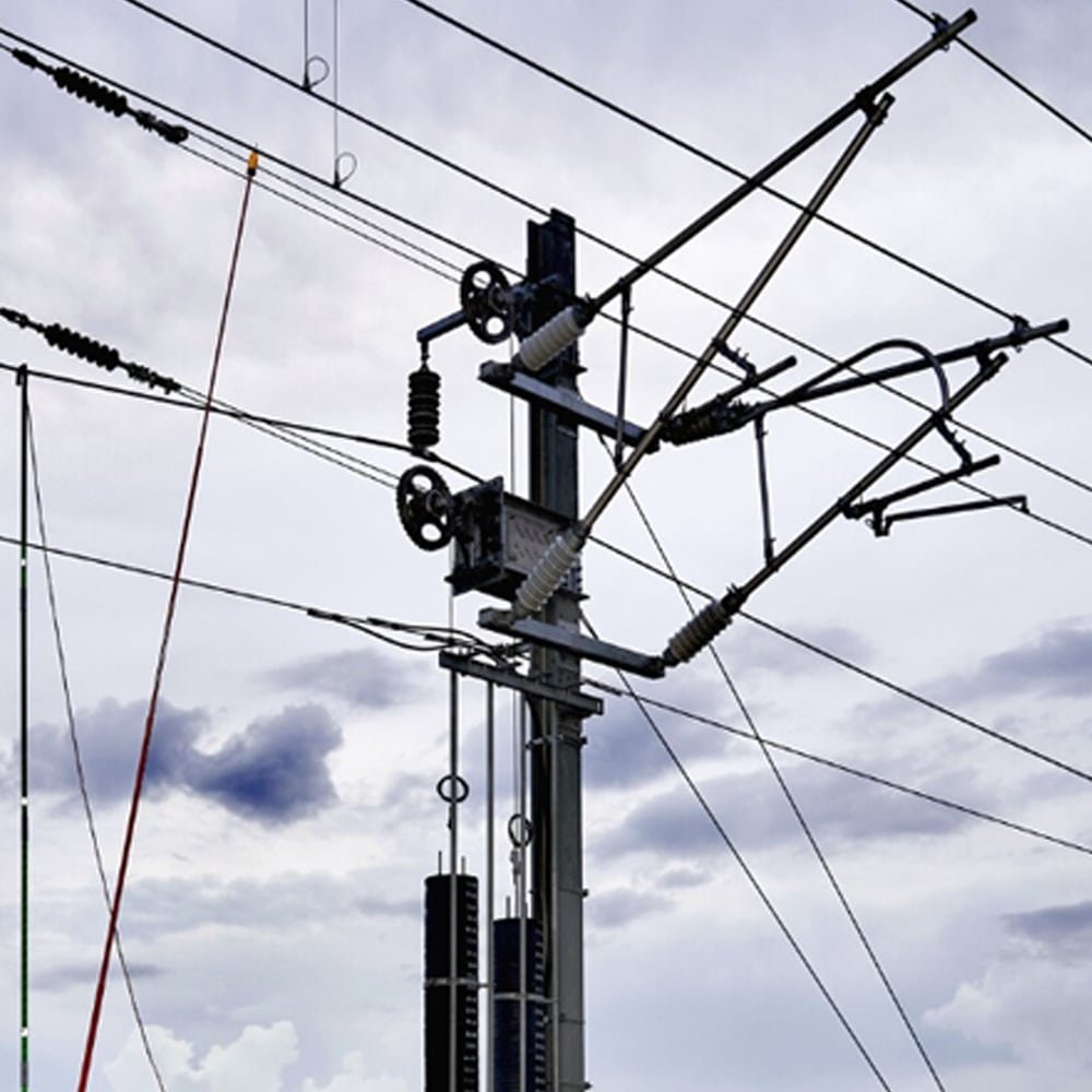 Hulk Cable dedicated cabling solution for electrified railway catenary system, featuring high-voltage feed and return cables mounted on support poles with insulators and tensioning devices for stable power transmission under extreme weather and dynamic pantograph contact
