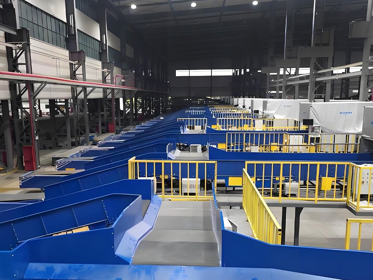 Large-scale automated parcel sorting center with blue conveyor chutes and yellow safety railings, powered and controlled by Hulk cables for reliable power and data transmission in high-density logistics environments