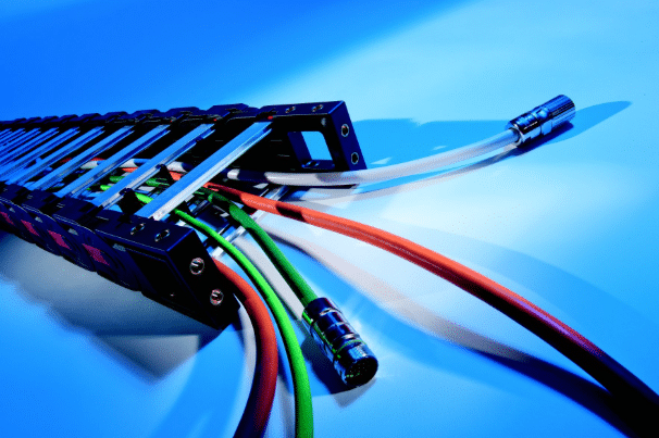Detailed shot of shielded cables carrying power and sensitive high-speed data signals inside a drag chain, emphasizing custom shielding needs for EMC and signal integrity in motion control